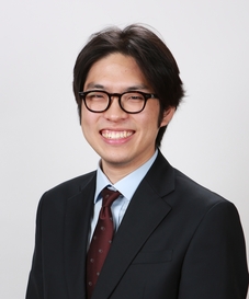 A portrait of me in a suit and a purple tie